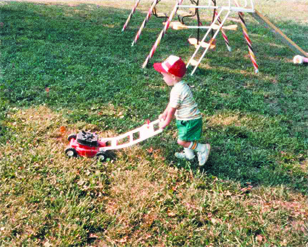 Apparently, Noah knew early on that landscaping and mowing were in his future. He is shown “mowing” grass as a youngster.